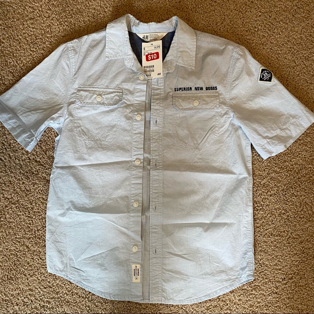 kids short sleeve light blue button up with embroidered lettering.